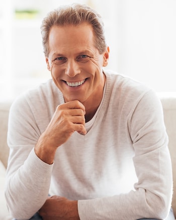 Smiling man who has a bridge using Dental Implants in Shelby Township 
